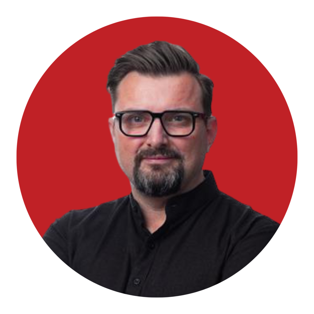 man with beard and glasses wearing black shirt on red background