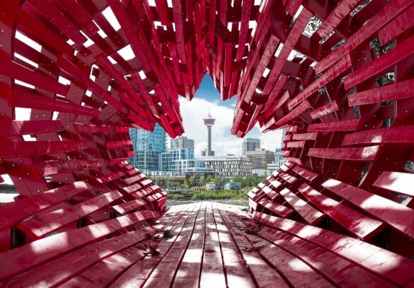 Calgary skyline seen through red art installation with focus on downtown towers and tower.