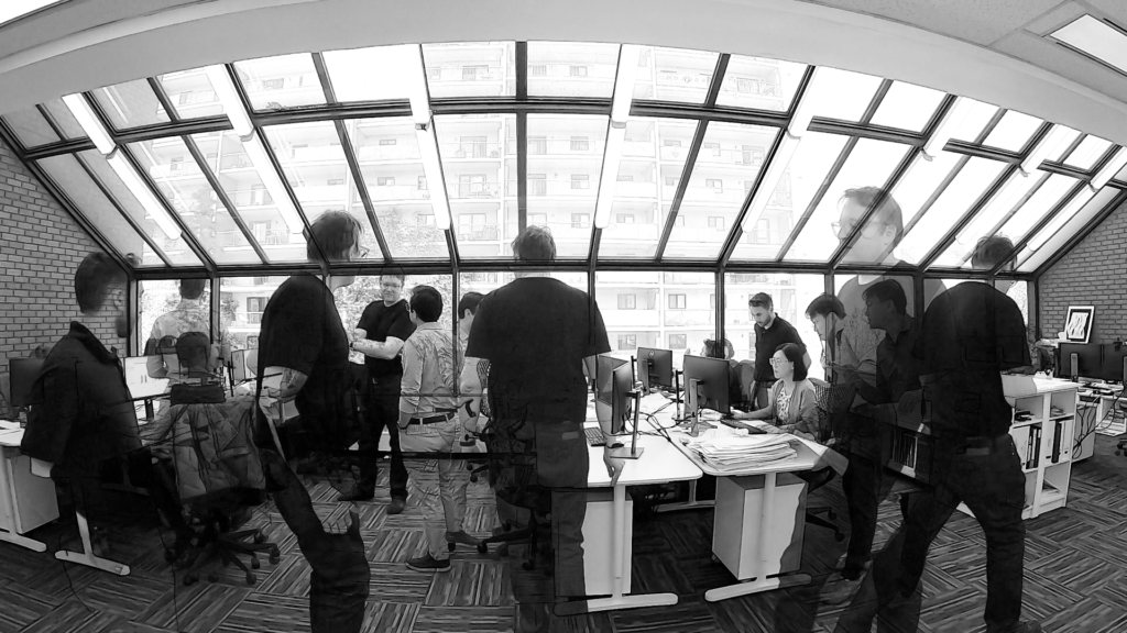 Team meeting in modern office with large windows and bright natural light
