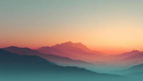 Layered hills at sunrise with pink and orange sky over teal mountains