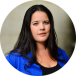 Professional headshot of Indigenous woman in blue cardigan.