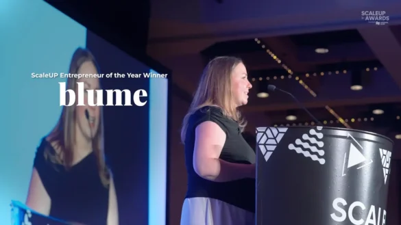 ScaleUP Entrepreneur of the Year Winner Blume accepts award at podium.