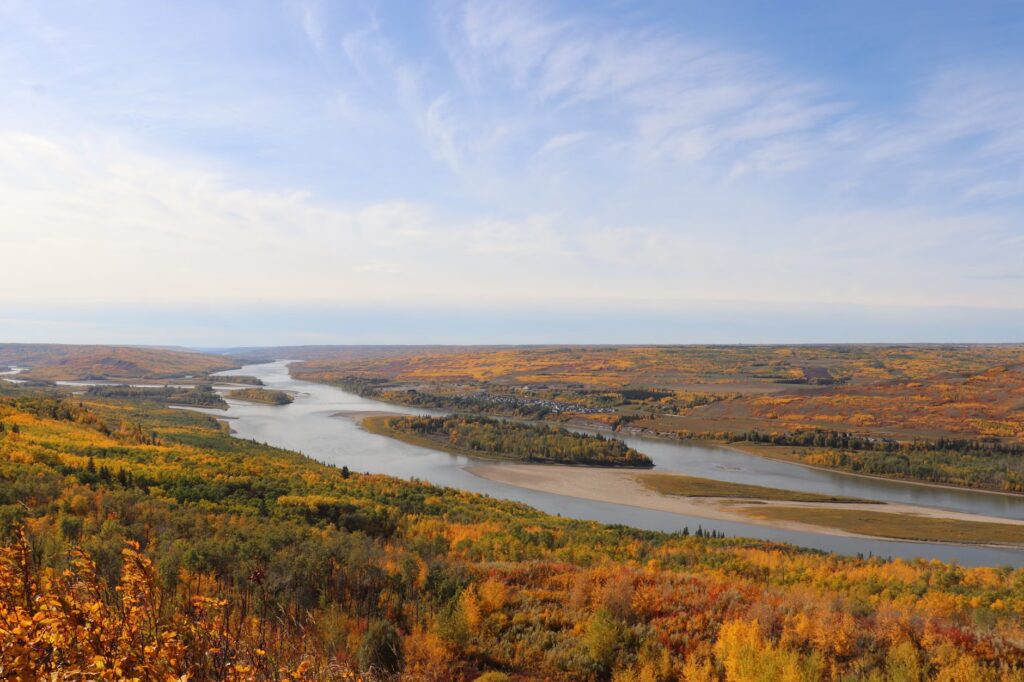 Explore the breathtaking autumn landscape of Peace River, Alberta, with vibrant foliage and winding river views.