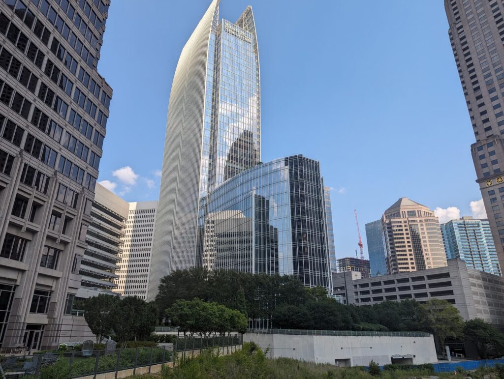 Majestic skyscrapers in downtown Atlanta reflect the sky on a sunny day, showcasing urban architecture.