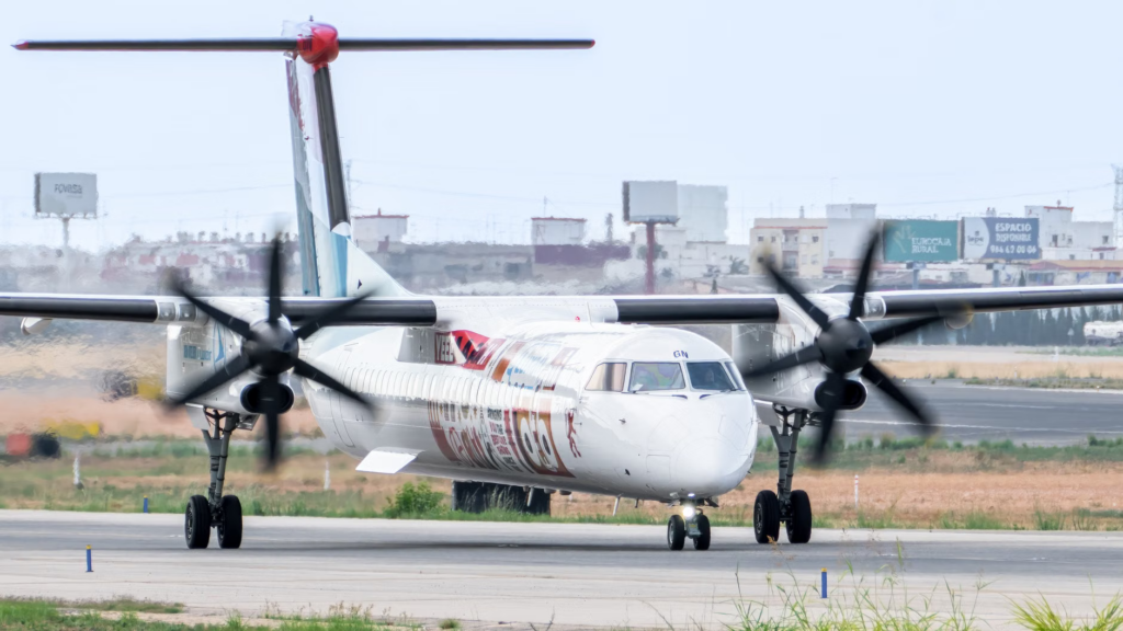 Bombardier Q400 turboprop aircraft preparing for takeoff at Manises Airport, Valencia.