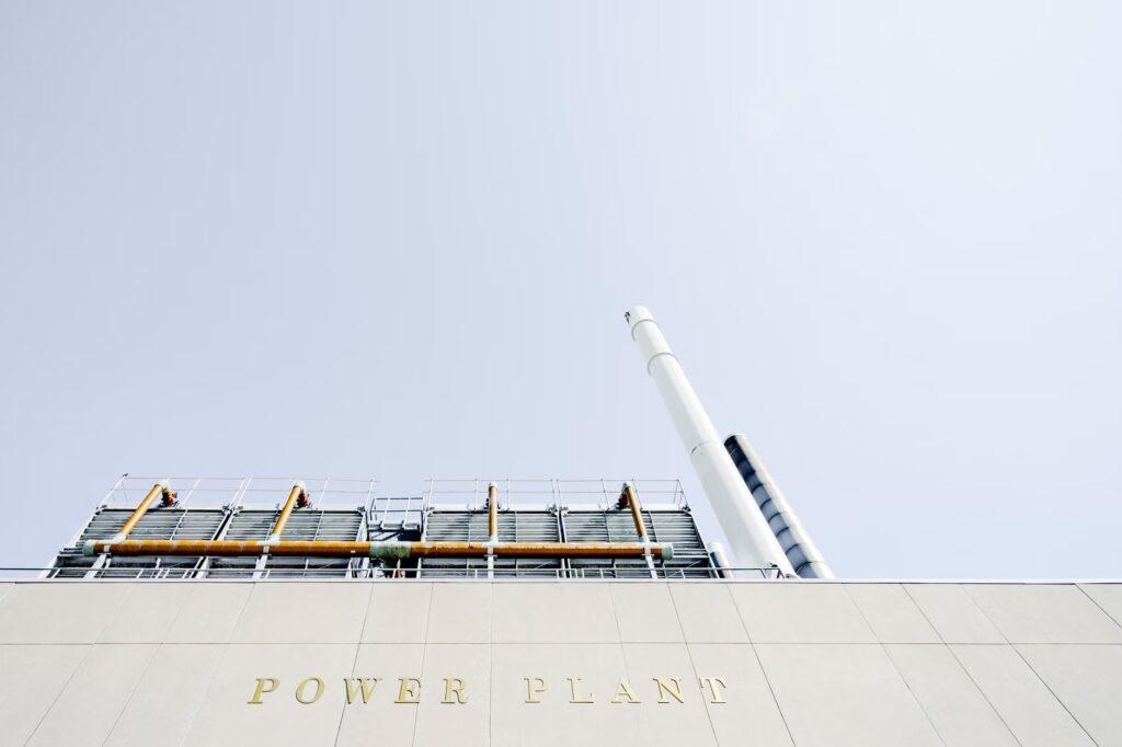 A modern power plant exterior with smokestacks under a clear sky in London, Ontario.