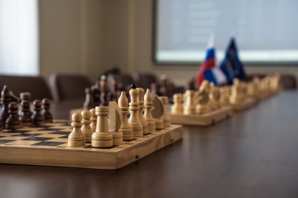 A detailed view of a chess board setup in a professional meeting room, highlighting strategy and planning.